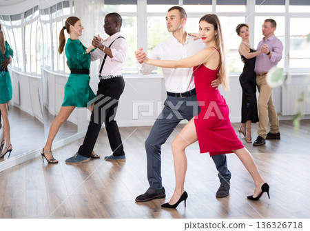 Young man and woman practicing waltz in dancing studio Young man and woman practicing waltz in dancing studio 136326718
