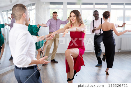Woman dances incendiary boogie woogie with man partner during choreography lesson Woman dances incendiary boogie woogie with man partner during choreography lesson 136326721