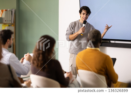 Portrait of male teacher lecturing to professionals during training meeting 136326899