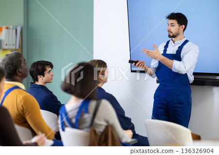 Man in shirt worker lecturer speaks to audience of listeners 136326904