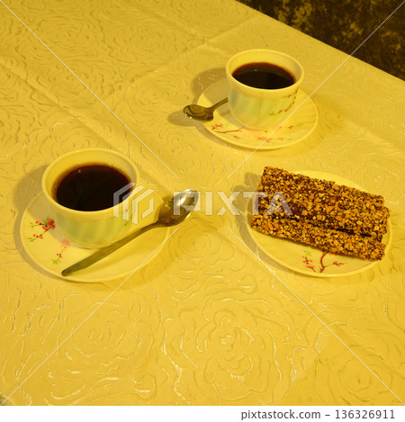 cups of coffee and dessert on a patterned surface cups of coffee and dessert on a patterned surface 136326911