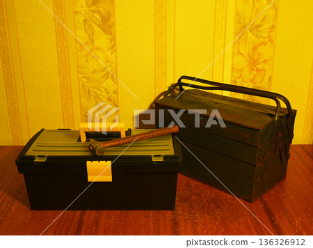 two toolboxes on a wooden floor 136326912
