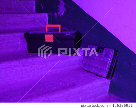 black toolbox with an orange handle on concrete steps black toolbox with an orange handle on concrete steps 136326931
