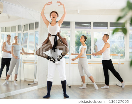 Adult man and adult woman rehearsing pair ballet 136327005