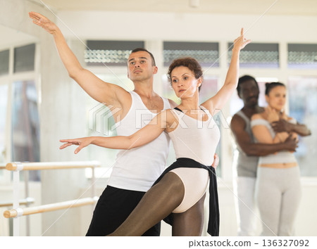 Ballet partners mastering paired technique during group class Ballet partners mastering paired technique during group class 136327092