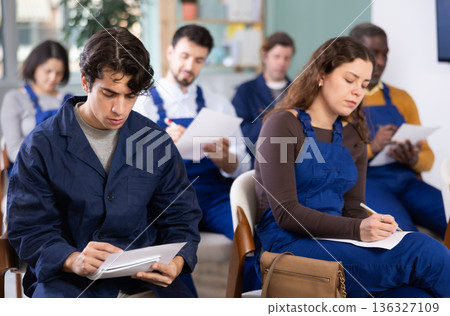 Multinational group workers listens and takes notes lectures in lecture hall Multinational group workers listens and takes notes lectures in lecture hall 136327109