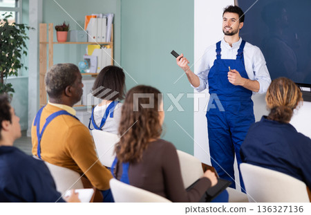 Male mentor teaches students new skills in vocational fields Male mentor teaches students new skills in vocational fields 136327136