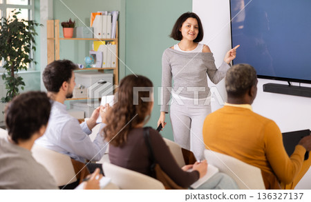 During lesson, Asian girl teacher tells material and gives lecture During lesson, Asian girl teacher tells material and gives lecture 136327137