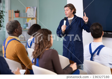 Male mentor teaches students new skills in vocational fields Male mentor teaches students new skills in vocational fields 136327180