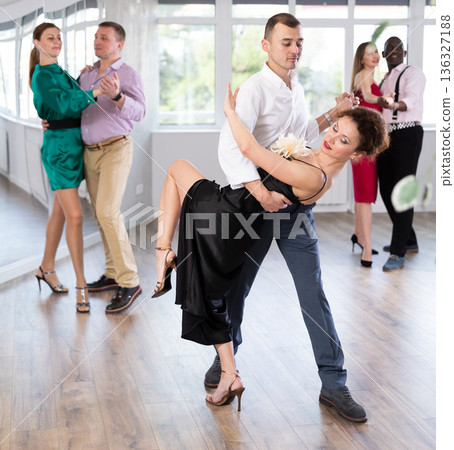 Woman and young man practicing waltz in dancing studio 136327188