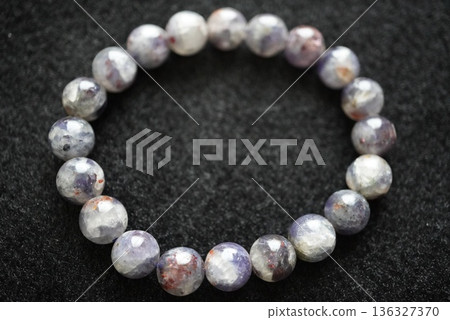 A natural iolite sunstone bracelet that stands out against a black background A natural iolite sunstone bracelet that stands out against a black background 136327370