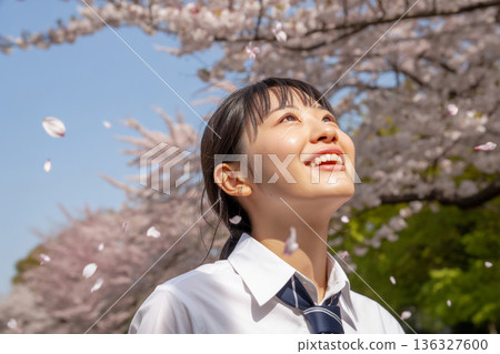 Smiling high school girl under the cherry blossoms Generative AI 136327600