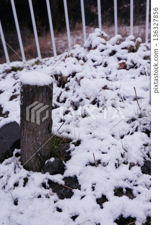 Snow piled up by the river 136327856