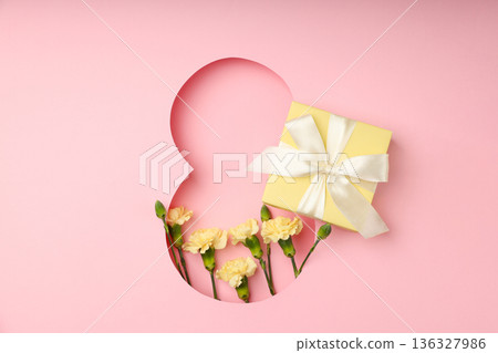 A cheerful gift box and flowers arranged for 8 March celebration A cheerful gift box and flowers arranged for 8 March celebration 136327986