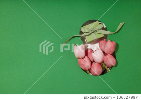 Pink tulips and a small gift create a cheerful spring scene Pink tulips and a small gift create a cheerful spring scene 136327987