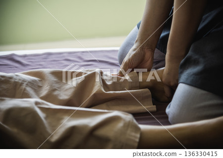 Massage Thai Spa foot massage. Close up woman leg side therapy relax treatment in spa salon. Spa body foot pain massage. Woman happy relax skin lying spa bed oil wellness body skincare therapist 136330415