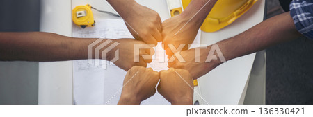 Banner Close up engineer men hands diversity multiethnic partners team together. Group of multiracial engineer Manager Foreman Teamwork meeting. Top view team join hands partnership with copy space 136330421