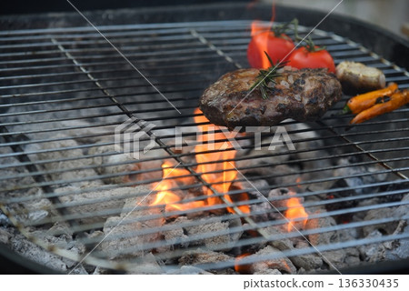 BBQ Barbecue grilled meat stick on fire flame with hot charcoal cooking outside. Beef grilling picnic outdoor with smoke bacon spicy sausage for party. Grill pork bbq on fire flame BBQ Barbecue grilled meat stick on fire flame with hot charcoal cooking outside. Beef grilling picnic outdoor with smoke bacon spicy sausage for party. Grill pork bbq on fire flame 136330435