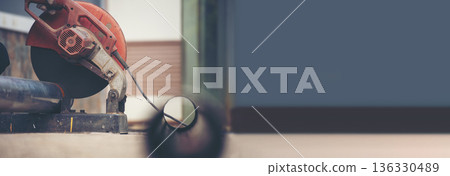 Banner Welding machine iron metal sparking. Hot flame welding metal work cutting fire iron workshop. Locksmith using machine cutting grinder process. Close up machinery metalworking with Copy Space 136330489