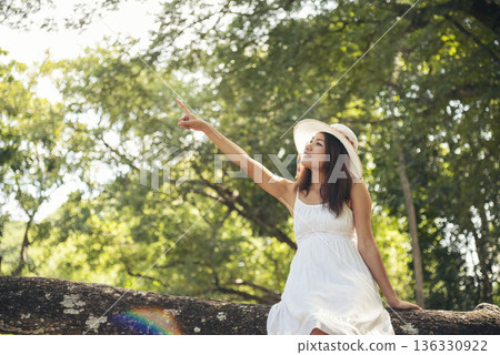 Portrait Asian Woman relaxing in green park. Happy Relax asian woman smiling face at outdoors garden. Young women enjoy nature freedom lifestyle. Greenery wellbeing outside beauty in nature. Portrait Asian Woman relaxing in green park. Happy Relax asian woman smiling face at outdoors garden. Young women enjoy nature freedom lifestyle. Greenery wellbeing outside beauty in nature. 136330922