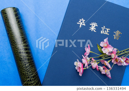 A bright graduation material with a diploma, a tube, and cherry blossoms A bright graduation material with a diploma, a tube, and cherry blossoms 136331494