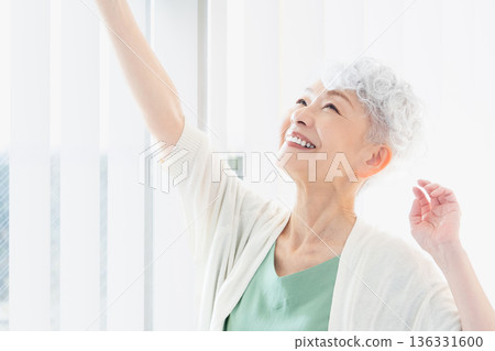 Senior woman spending time by the window in the morning 136331600
