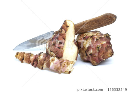 Jerusalem artichokes with a knife on a white background, ready to be prepared Jerusalem artichokes with a knife on a white background, ready to be prepared 136332249