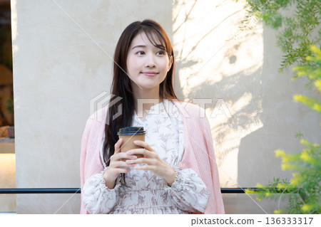 Young woman relaxing on the cafe terrace Young woman relaxing on the cafe terrace 136333317