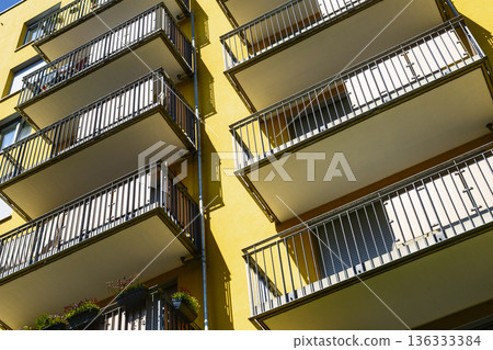 Modern yellow apartment building facade 136333384