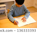 Hands of a child writing in a notebook 136333393