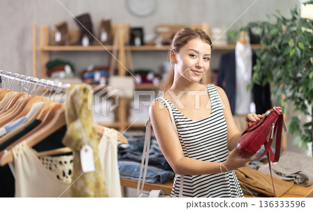 Woman choosing a handbag in a store 136333596