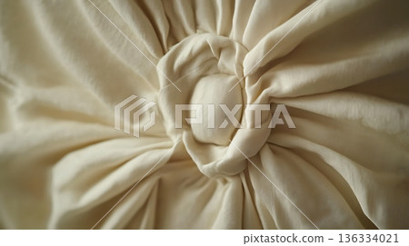 A white pillow with a flowery design on it 136334021