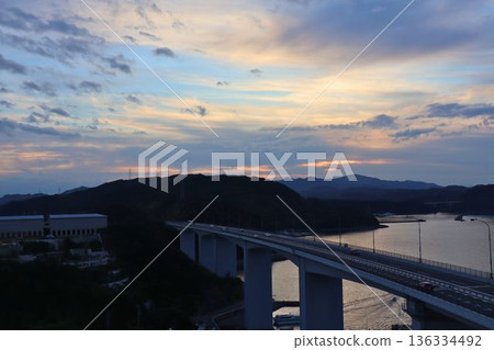Beautiful scenery of the bridge and waterfront at dusk Beautiful scenery of the bridge and waterfront at dusk 136334492