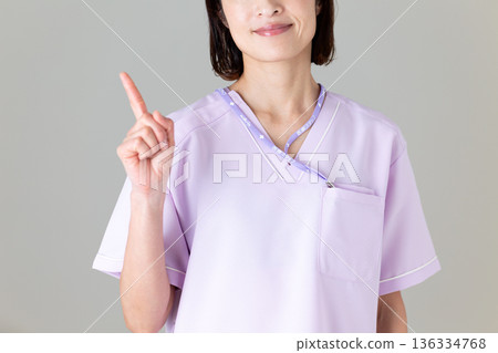 A middle-aged female nurse in a medical scrub 136334768
