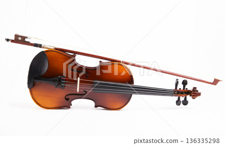 Violin with a bow on a white background 136335298