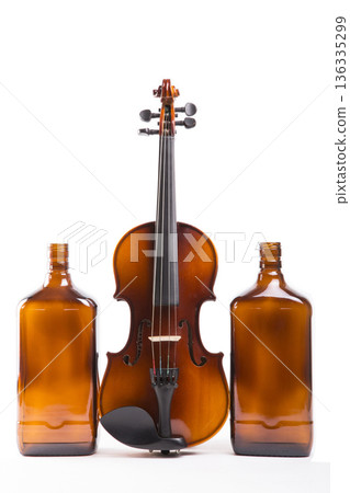 Still life with a violin and a bottle on a white background 136335299
