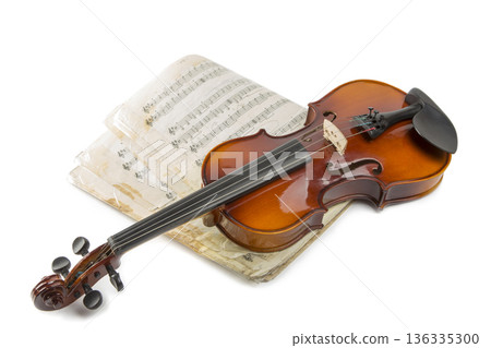 Still life with a violin and music book on a white background Still life with a violin and music book on a white background 136335300