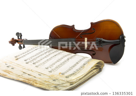 Still life with a violin and music book on a white background Still life with a violin and music book on a white background 136335301