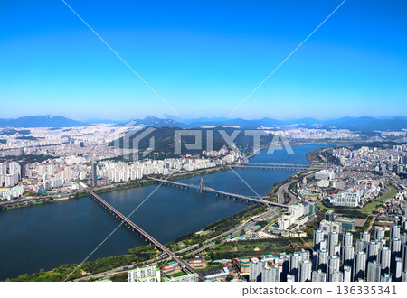 Aerial view cityscape of Seoul. Top view of Seoul, capital of South Korea. High angle view of Seoul with modern residential neighbourhoods, Han River and mountains 136335341