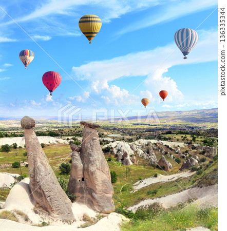 Balloon flight, famous tourist attraction of Cappadocia. Air balloons and Fairy Chimney in Pasabag Valley, Anatolia, Turkey. Topic of vacation, travel, trip abroad on vacation, cruises and tours 136335344