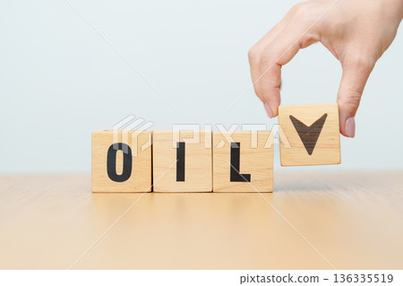 Hand change wooden block with OIL text to UP and Down arrow symbol icon. Trade war, stocks, financial, cut loss and economic concept 136335519