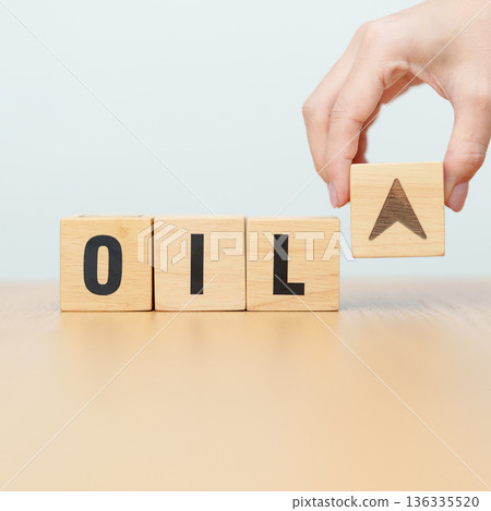 Hand change wooden block with OIL text to UP and Down arrow symbol icon. Trade war, stocks, financial, cut loss and economic concept 136335520