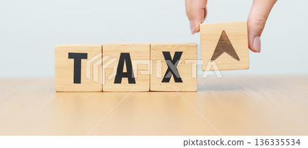 hand change wooden block with TAX text to UP and Down arrow icon. decrease and Increase, Taxpayer, Taxable Income, Tax Filing, Deduction, Withholding Tax, WHT, VAT, Computation and Exemption concept 136335534