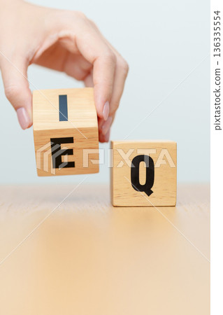 hand change wooden block from IQ to EQ, balance between intelligence quotient and emotional quotient, AQ Adversity, MQ, Moral, SQ and Social quotient concepts hand change wooden block from IQ to EQ, balance between intelligence quotient and emotional quotient, AQ Adversity, MQ, Moral, SQ and Social quotient concepts 136335554