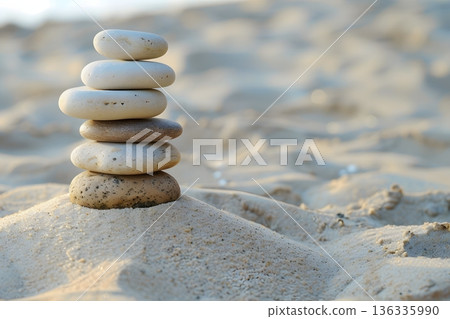 Zen stones piled on the sand symbolize harmony and balance. Zen stones piled on the sand symbolize harmony and balance. 136335990