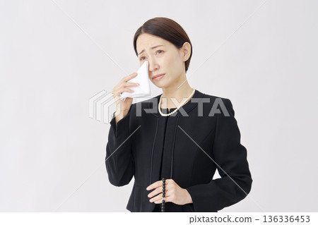 Woman in mourning clothes crying white background Woman in mourning clothes crying white background 136336453