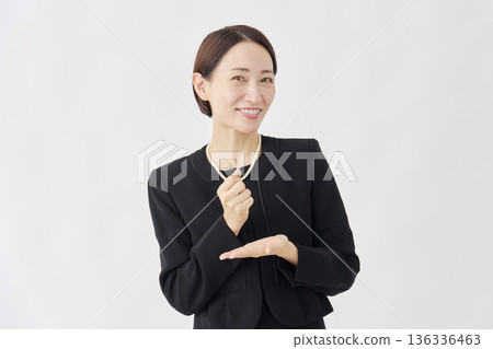 Woman in fluttering mourning clothes, white background, looking at camera Woman in fluttering mourning clothes, white background, looking at camera 136336463