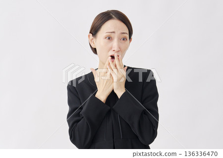 Surprised woman in mourning clothes, white background, facing right Surprised woman in mourning clothes, white background, facing right 136336470