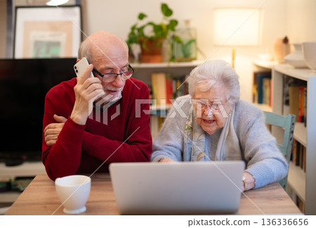 Old people having problem with laptop, calling for help. Old people having problem with laptop, calling for help. 136336656