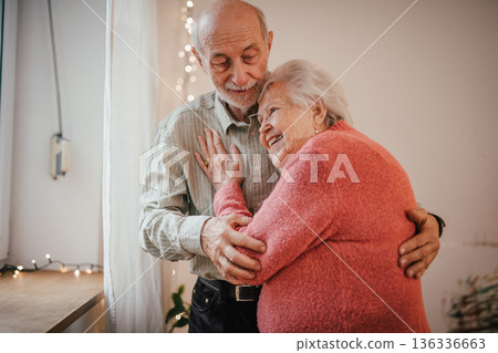 Romantic moment for senior couple at home, celebrating Valentines day. Romantic moment for senior couple at home, celebrating Valentines day. 136336663
